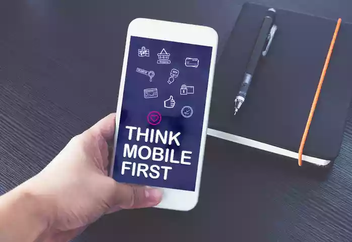 a phone that shows on the screen the words 'Mobile First'